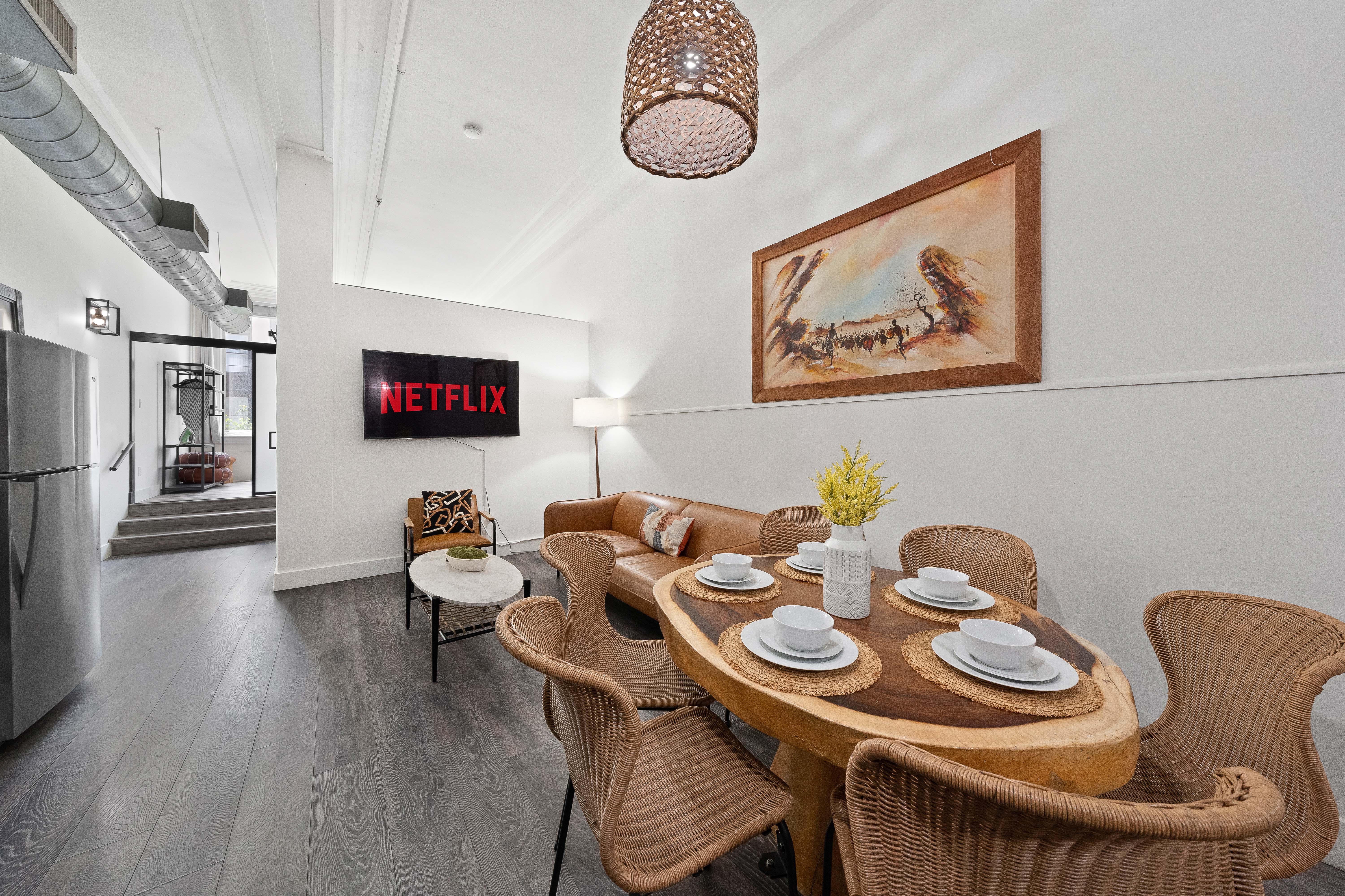 Unit 202 Safari — wicker dining table and warm earthy tones