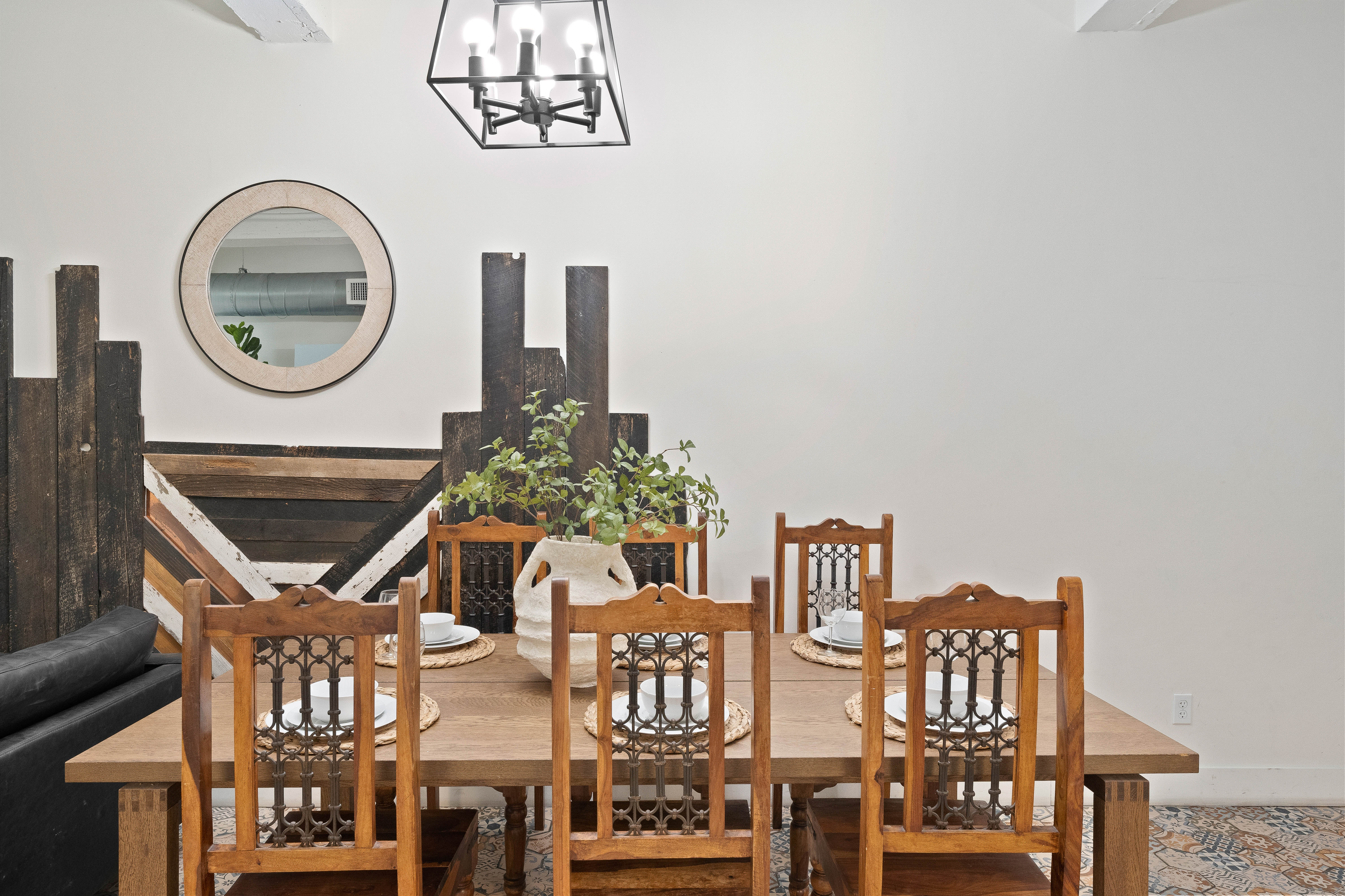 Unit 302 Villa — farmhouse dining table with dark wood accent wall
